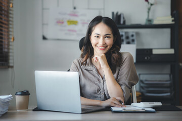 Asian women working in the office, young Asian business women as business executives, founding and running start-up executives, young female business leaders. Startup business concept.