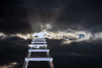 Dramatic religious background.Sunset or sunrise with dark clouds,blurred stairs to heaven,stairway leading up to skies clouds.Light from sky.Religion concept.Blurred soft image.Copy space.