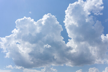 Naklejka na ściany i meble White clouds on a blue sky in summer. Wide angle shot