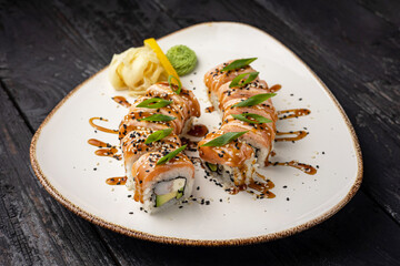 sushi roll with wasabi and sesame seeds on the plate. delicious food, close-up