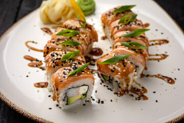 sushi roll with wasabi and sesame seeds on the plate. delicious food, close-up