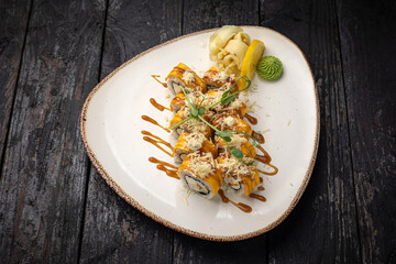sushi roll with wasabi and sesame seeds on the plate. delicious food, close-up