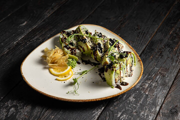 sushi roll with wasabi and sesame seeds on the plate. delicious food, close-up