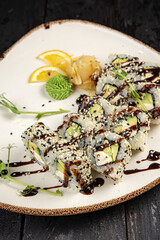 sushi roll with wasabi and sesame seeds on the plate. delicious food, close-up