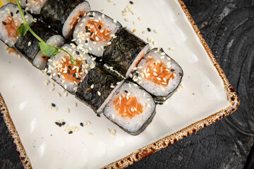 sushi roll with wasabi and sesame seeds on the plate. delicious food, close-up