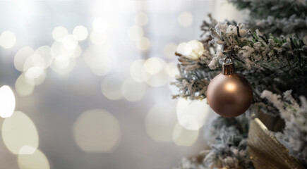 Fototapeta na wymiar Golden ball on christmas tree with bokeh background.
