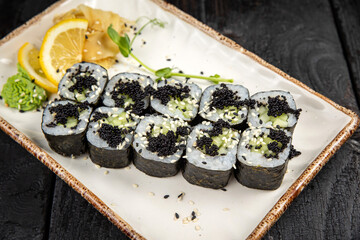 sushi roll with wasabi and sesame seeds on the plate. delicious food, close-up