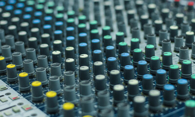 Sound check for the concert. Mixer control. Music engineer. Buttons and tabs in various parts of the audio controller. Selective focus.