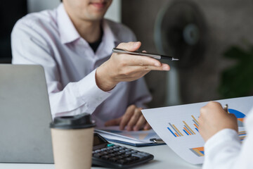 Business people discussing and meeting in board rood with paper chart on desk.