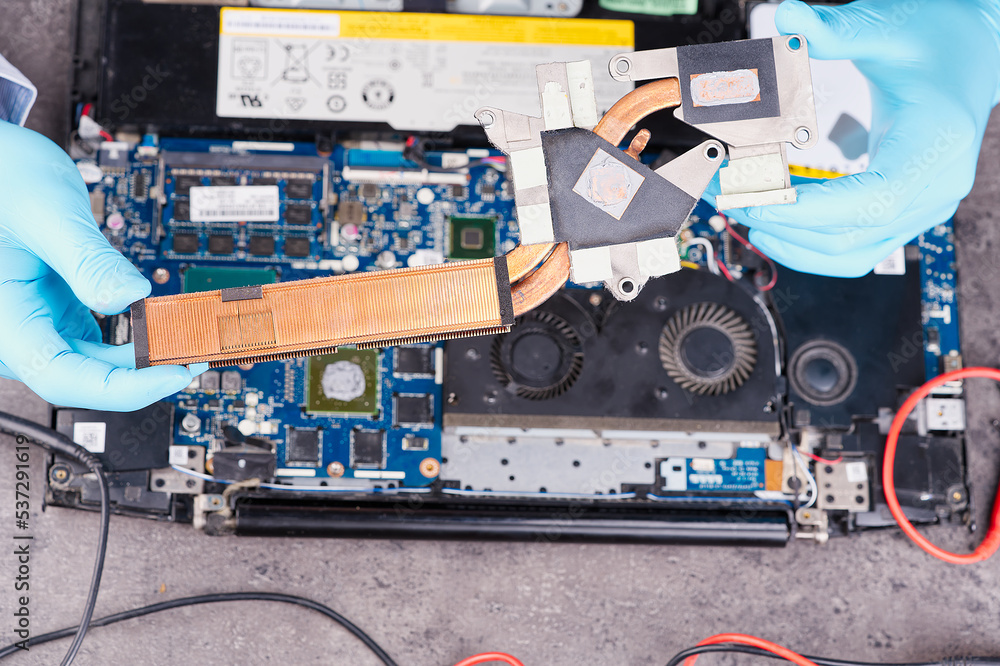 Poster hands fixing motherboard of pc or laptop notebook close up in service. laptop repair service. pc har