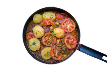Meat in the pan with broth and vegetables