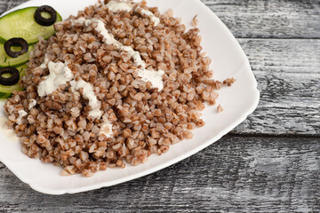Buckwheat, boiled buckwheat on a wooden white background