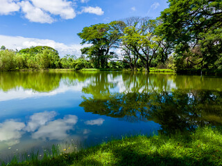 Fototapeta na wymiar Scenery garden and lake river with tree for rest relax in Kanchanaburi , Thailand