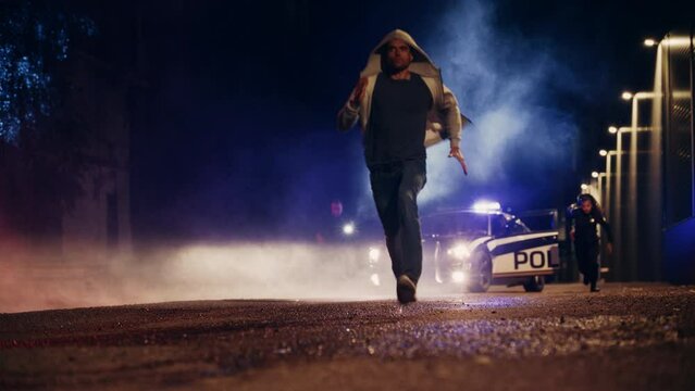 Two Police Officers in Pursuit of a Suspect. Cops Getting out of the Car Start Chasing Criminal on Foot Through the Dark City Streets. Heroic Officers Catching and Arresting Drug Dealer, Murdered