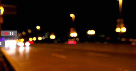 Composite of message icon and 16 number over defocused road with illuminated street lights at night - Powered by Adobe