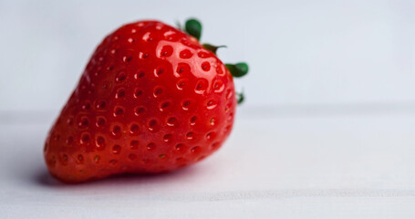 Close up of fresh strawberry over white wooden table, copy space