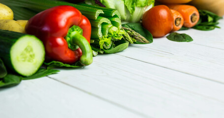 Close-up of various fresh raw vegetables arranged over wooden table, copy space