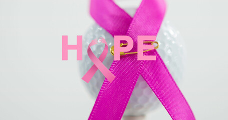 Composite of hope text with pink awareness ribbon pinned on white ball, copy space
