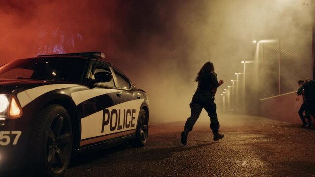 Two Police Officers Catch and Arrest Suspect. Heroic Officers of the Law Tackle and Stop Dangerous Criminal on the Dark City Street. Cops Arresting Felon, Fight Crime. Dramatic Cinematic Slow Motion