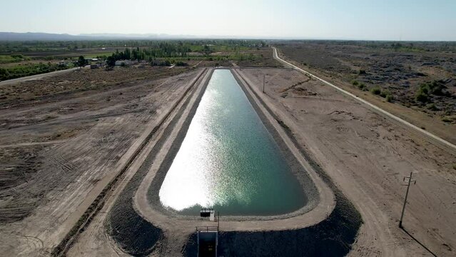 Aerial video of artificial water reservoir for agricultural irrigation.