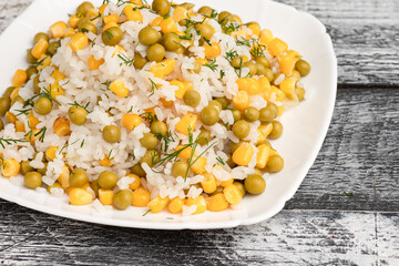 Rice, boiled rice with peas on a wooden white background