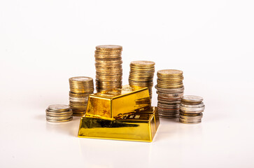 Shiny gold bar with coins in white background - financial concept