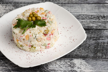 Salad, olivier salad on a wooden white background