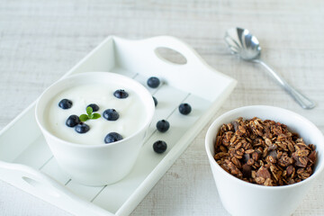 Homemade granola with blueberries and yoghurt on a table Healthy food, clean eating, dieting concept
