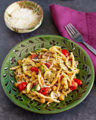 Rustic homemade italian pasta with autumn roasted vegetables and parmesan cheese