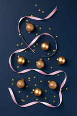 Christmas card with golden glitter balls, confetti and satin ribbon on dark blue background