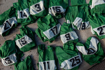 Stockholm, Sweden Numbered green sport team jerseys lay on the ground for use in a grou pactivity.