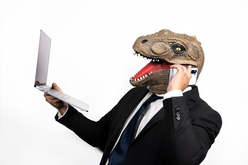 businessman with t rex head at a conference using his laptop and cellphone on white background