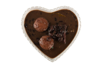 Feijoada in heart bowl top view. Brazilian food.