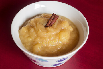 Fresh homemade Applesauce with cinnamon on a colorful studio background.  Healthy food.