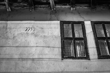 Abandoned house in Northern Bulgaria, black and white picture, partial building view with number saying 991, nine hundred and ninety one