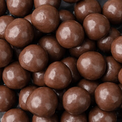 Closeup of chocolate malted balls. Candy backdrop