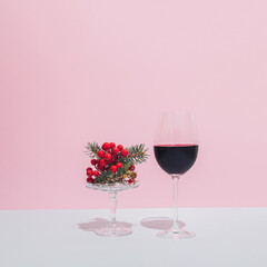 Minimal Christmas and New Year composition with glass of red wine and Christmas decorations.
