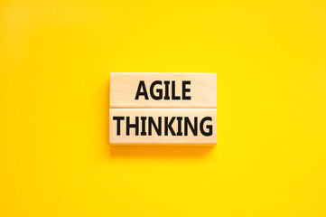 Agile thinking symbol. Concept words Agile thinking on wooden blocks. Beautiful yellow table yellow background. Business flexible and agile thinking concept. Copy space.