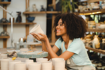 happy smiling girl having fun to learning and work with craft art of clay hand-made workshop in ceramic studio, little ceramist enjoy in creative handcraft hobby with pottery artisan school class
