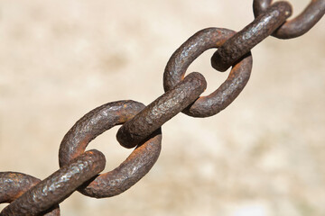 Detail of an old rusty metal chain isolated on colored background - image with copy space