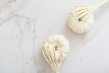 white halloween pumpkins with decor on marble background