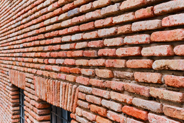 Brick facades of old houses, renovation of houses in old cities. The idea of a background or screensaver from red old brick, wallpaper design for loft apartments.