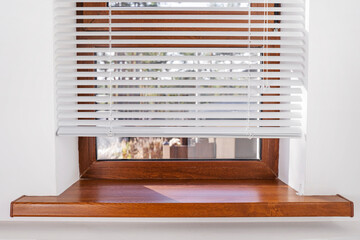 Blinds horizontal and Window with window sill.