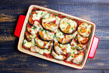 Baked eggplant with cheese mozzarella and tomatoes. Healthy eating. Italian food. Parmigiana di melanzane.