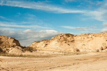 Fototapeta na wymiar sand quarry, in the photo, a quarry for the extraction of sand against a blue sky