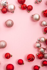 Decorative red and pink balls on a pink background. Top view, flat lay.