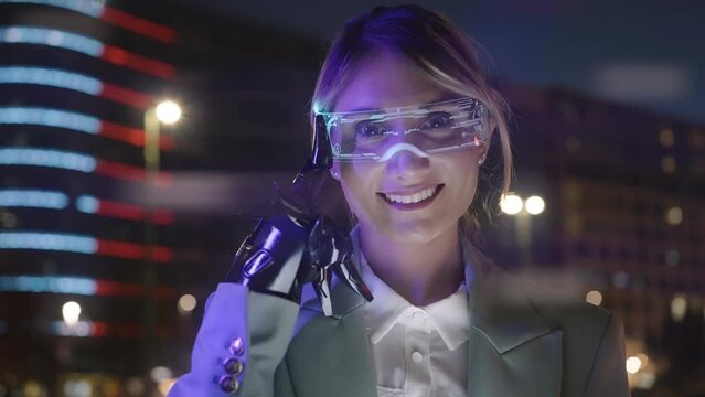Cinematic footage of a business woman with cyborg bionic arm and augmented reality visor. Representation of the future that will include human being and tech parts - cyberpunk look video