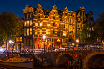 Fototapeta na wymiar Typical Houses on the Amsterdam Canal at Night