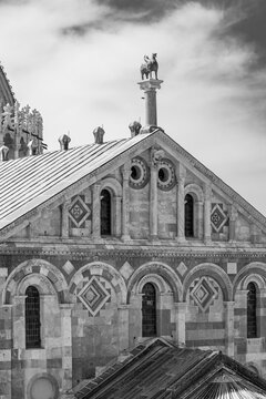 Black and white photo of front facade of gothic catholic basilica in Pisa