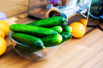 Cucumbers in a glass plate on a wooden table. The process of preparing a vegetable dish. Close-up. selective focus